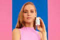 Woman holding an H-500 supplement bottle